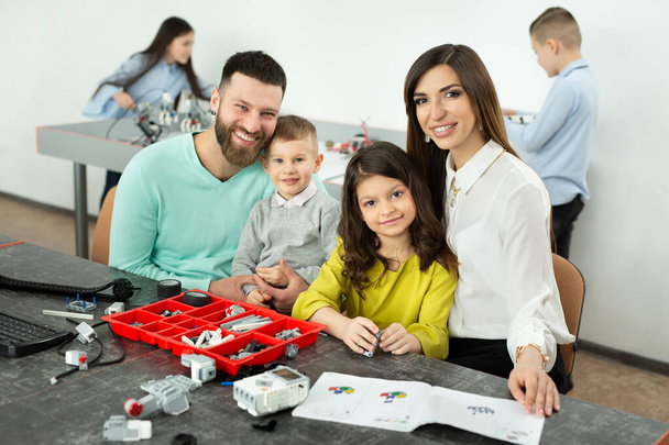 Family with children in a robotics club makes a robot controlled from a constructor - Fotografie, Obrázek