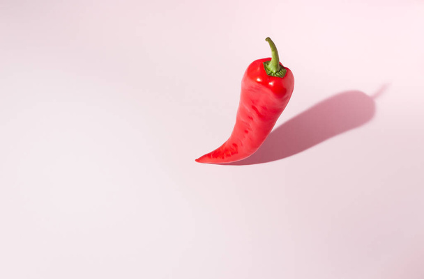 Top view of a red pepper on a pink background. Minimal concept. - Foto, Imagem
