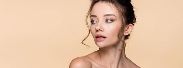 Brunette model with naked shoulders isolated on beige, banner  - Foto, afbeelding