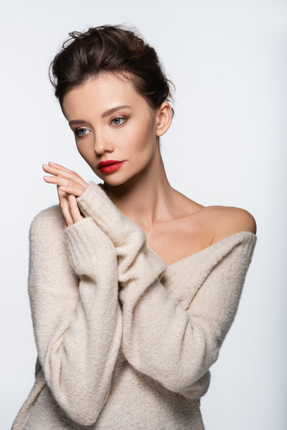 Stylish model in cozy sweater posing isolated on white - Fotó, kép