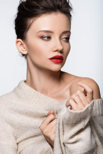 Stylish brunette model posing in warm sweater isolated on white - Fotó, kép