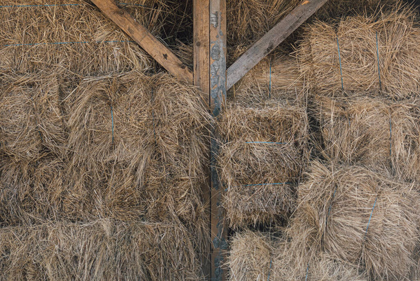 Hay bales storage on a shed from a countryside farm. Rural lifestyle   - Fotoğraf, Görsel