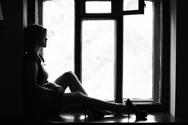 Woman sitting on the windowsill - Photo, Image