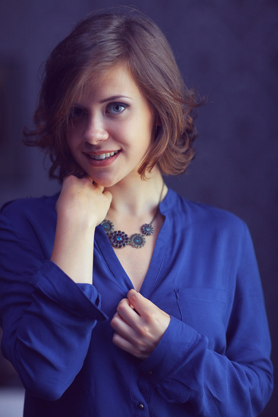 Brunette woman in blue shirt - Photo, Image