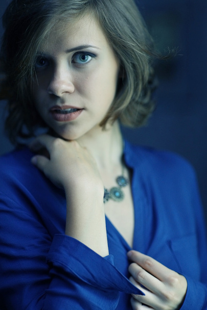 Brunette woman in blue shirt - Фото, изображение