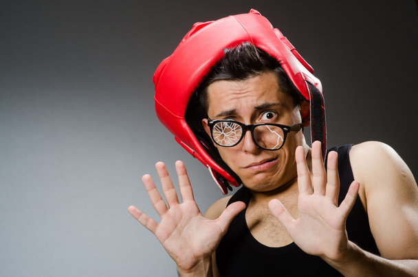 Funny boxer with red gloves against dark background - Foto, Bild