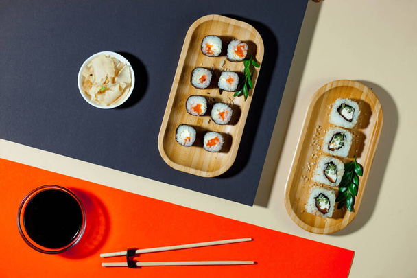 Sushi on a plate on a bright, colored background. - 写真・画像