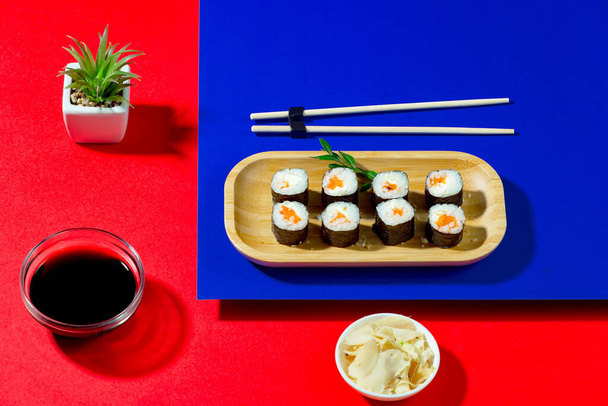 Sushi on a plate on a bright, colored background. - Fotografie, Obrázek