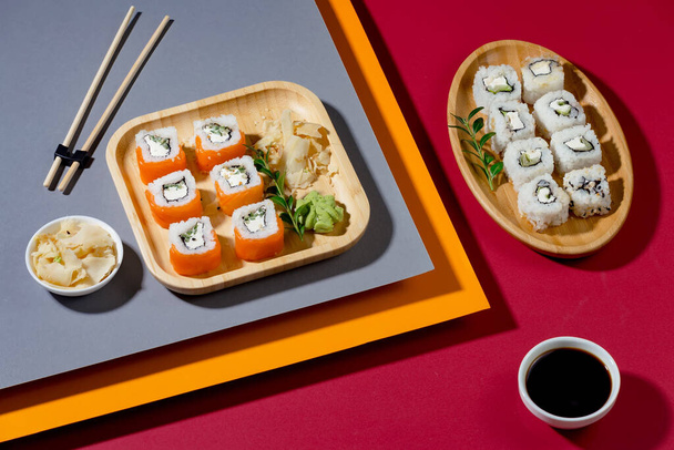Sushi on a plate on a bright, colored background. - Fotoğraf, Görsel