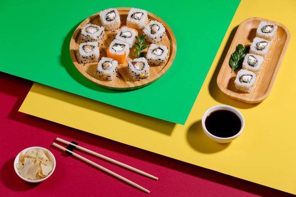 Sushi on a plate on a bright, colored background. - Φωτογραφία, εικόνα