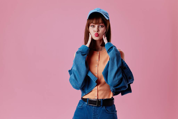 Pretty young female denim clothing fashion posing cap color background unaltered - Фото, зображення