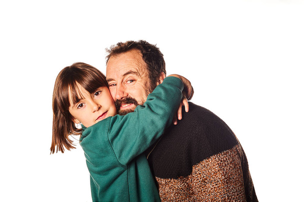 happy daughter hugging her father on an isolated white background on Father's Day - Fotó, kép