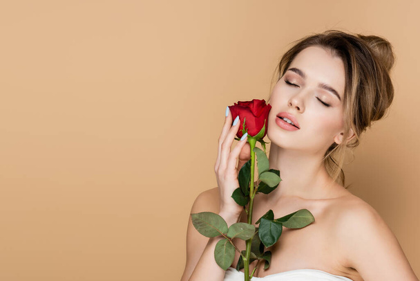 sensual woman with closed eyes and red rose near perfect face isolated on beige - Photo, Image
