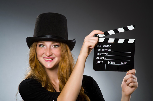 Nő film clapboard szürke háttér - Fotó, kép