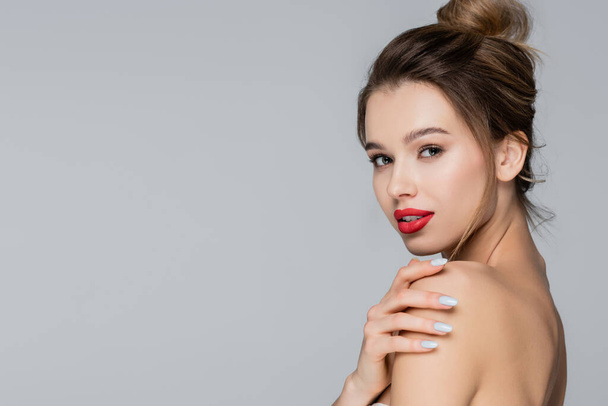 sensual woman with red lips looking at camera isolated on grey - Foto, Bild