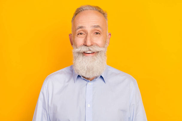 Photo of funny cool age gentleman wear blue shirt smiling isolated yellow color background - Fotó, kép