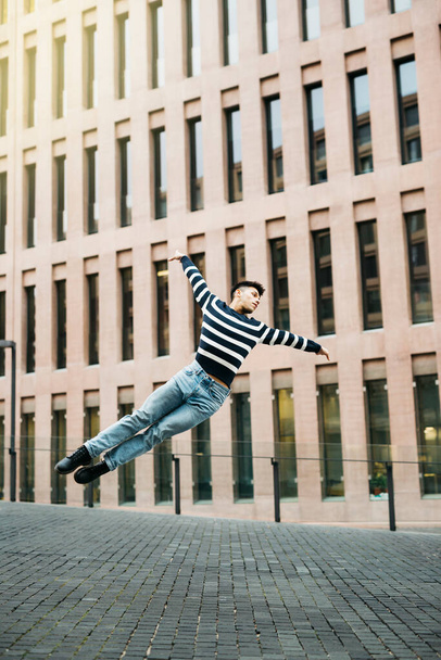 Young man jumping on the street - Fotoğraf, Görsel