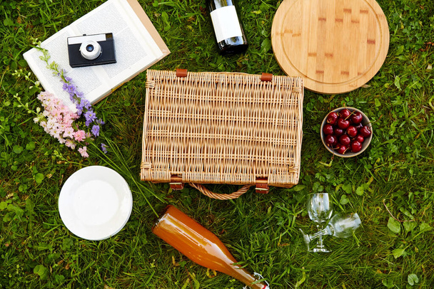 food, drinks and picnic basket on grass - Photo, Image