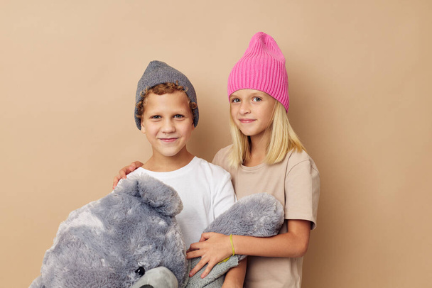 Little boy and girl standing next to posing toy emotions Lifestyle unaltered - Valokuva, kuva