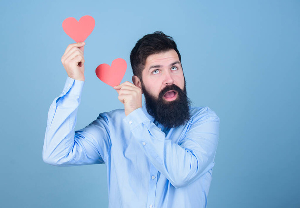 Celebrate love. Guy attractive beard and mustache in romantic mood. Feeling love. Dating and relations concept. Happy in love. Making man feel loved. Man bearded hipster with heart valentine card - Фото, зображення