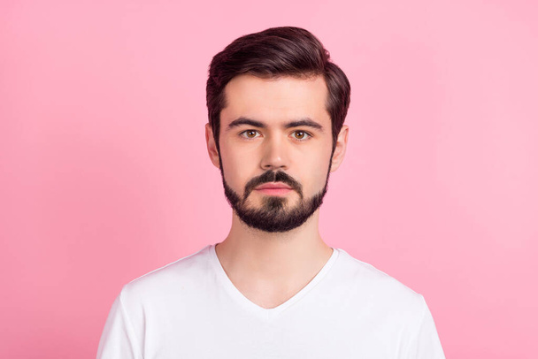 Photo of calm focused concentrated bearded guy look camera wear white t-shirt isolated pink color background - 写真・画像
