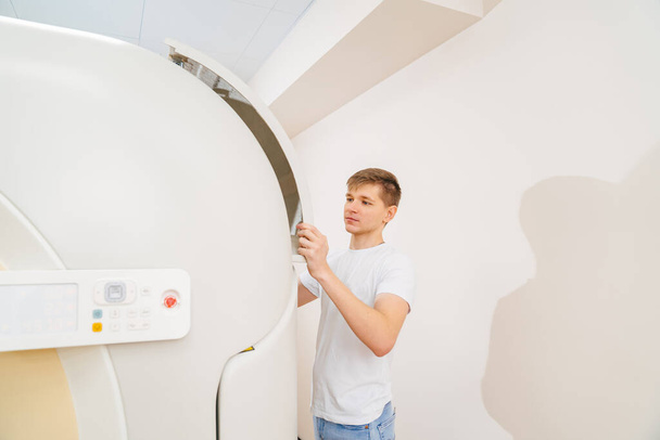 engineer removes cover of a computer tomograph.  - Fotografie, Obrázek