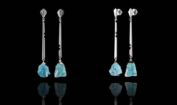 Beautiful gold earrings with aquamarine and diamonds on a black background - Photo, Image