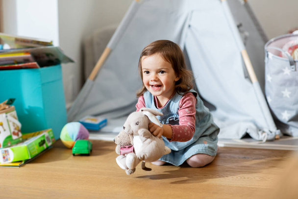 happy baby girl playing with soft toys at home - Valokuva, kuva