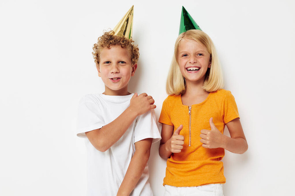 Cute stylish kids posing emotions holiday colorful caps isolated background unaltered - Photo, Image
