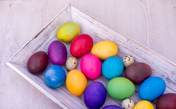 colorful Easter eggs on white wooden background - 写真・画像