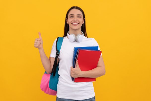 cheerful lady in headphones hold copybook carry backpack showing thumb up, september - Photo, Image