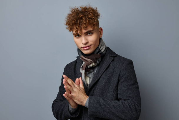 handsome young man elegant style self confidence fashion Gray background - Valokuva, kuva
