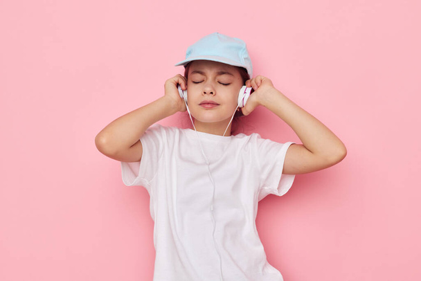 pretty young girl wearing headphones posing emotions isolated background - Foto, immagini