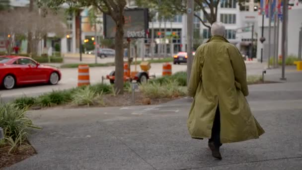 Walking behind a man in a trench coat - Footage, Video