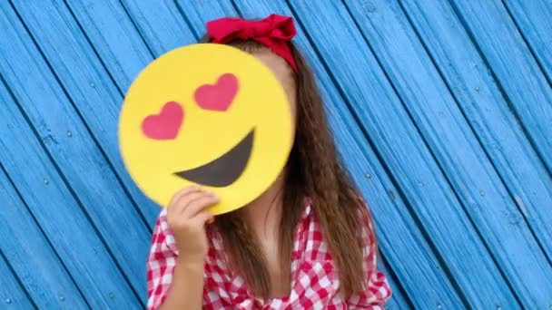 Curly-haired cute girl changes emoticons faces from a lover to a smiling one.  - Footage, Video