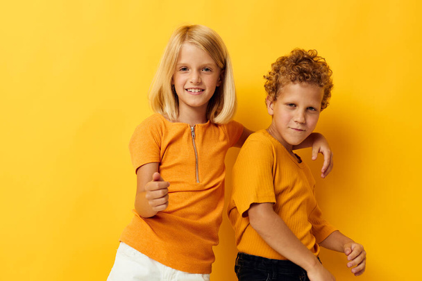 Retrato de niños lindos ropa casual juegos diversión juntos posando sobre fondo de color - Foto, imagen