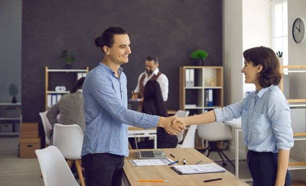 Young man and mature woman handshake in office after job recruitment meeting - Photo, image