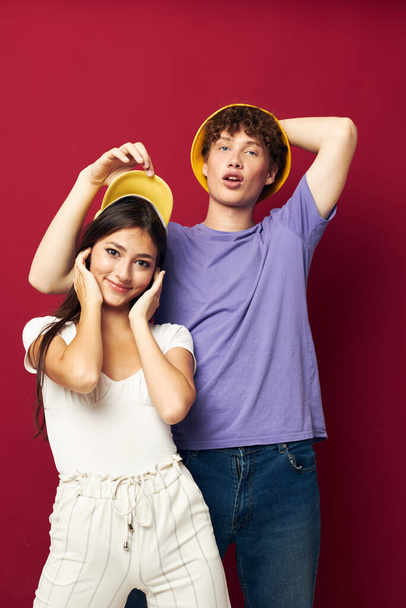 nice guy and girl stand side by side fashion modern style home fun red background - 写真・画像