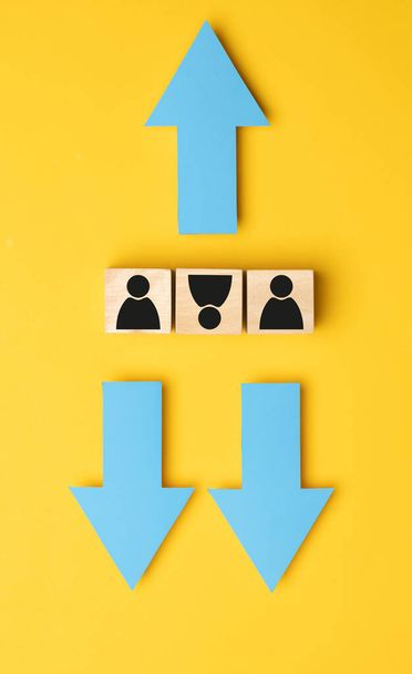 Wooden cubes with arrows in opposite directions on a yellow background. Concept of thinking differently, Business growth, Improvement, strategy, Success. - Photo, Image