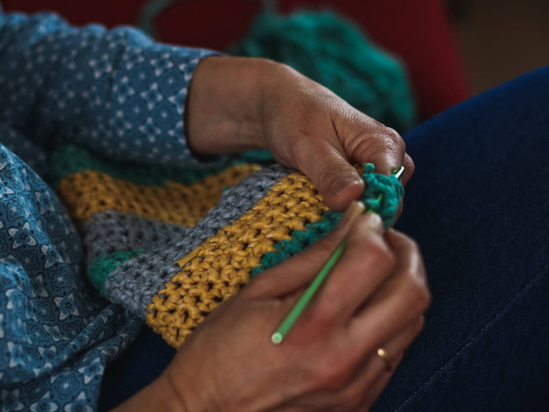 Hands of a middle aged woman sewing in her house - Foto, Imagen