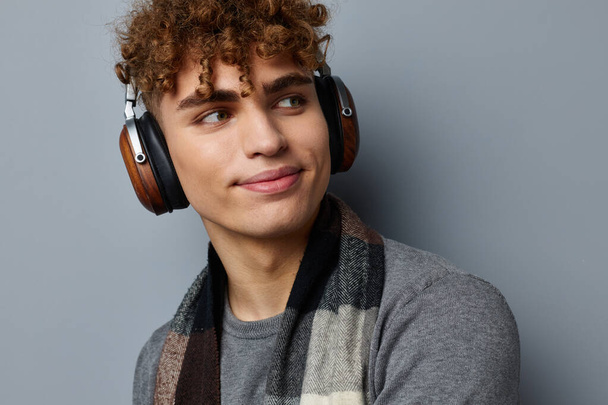 stylish guy elegant style checkered scarf headphones light background - Foto, afbeelding