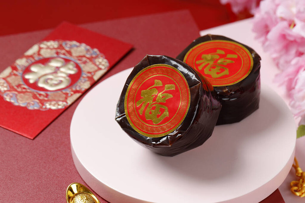 Chinese New Year Cake with Chinese character Fu means Fortune. Popular as Kue Keranjang or Dodol China in Indonesia. Imlek Red Concept Decoration - Photo, Image