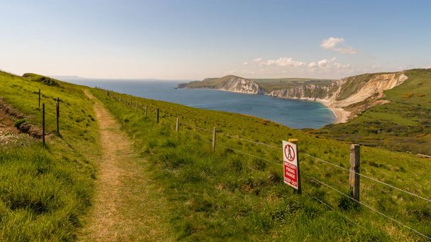 Walking on the South West Coast Path, looking at Worbarrow Bay, near Tyneham, Jurassic Coast, Dorset, UK - Фото, зображення