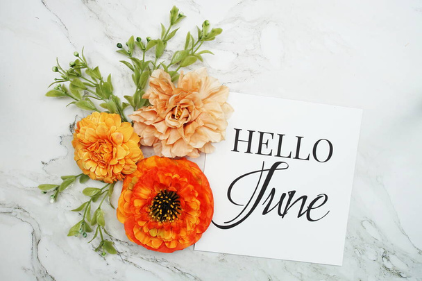 Hello June text with orange flower bouquet on marble background - Zdjęcie, obraz
