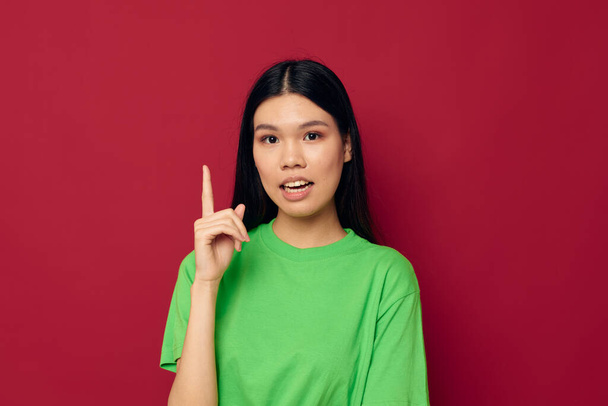Charming young Asian woman emotions posing gesture hands grimace red background unaltered - Φωτογραφία, εικόνα