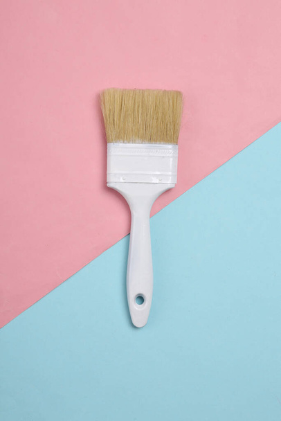 Paint brush on a blue-pink pastel background. Top view - Photo, Image