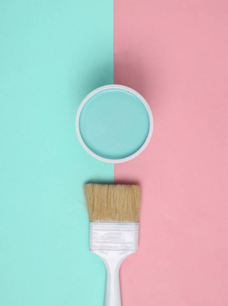 Paint Can with paintbrush on pink blue background. Top view - Фото, изображение