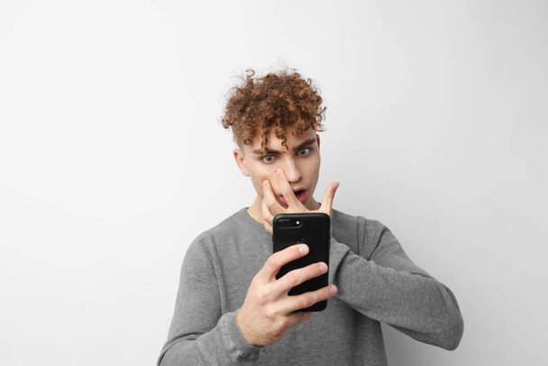 handsome guy looking at the phone fashion Lifestyle unaltered - Фото, зображення