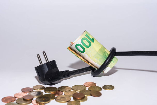 Augmentation des prix de l'énergie et de la consommation d'énergie câble d'alimentation avec noeud et argent avec fond gris - Photo, image