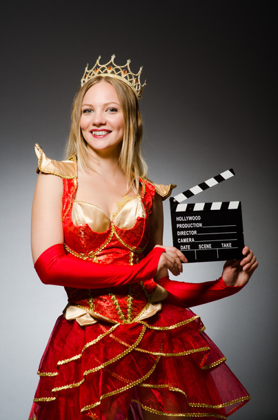 Queen in red dress with movie clapboard - Photo, Image